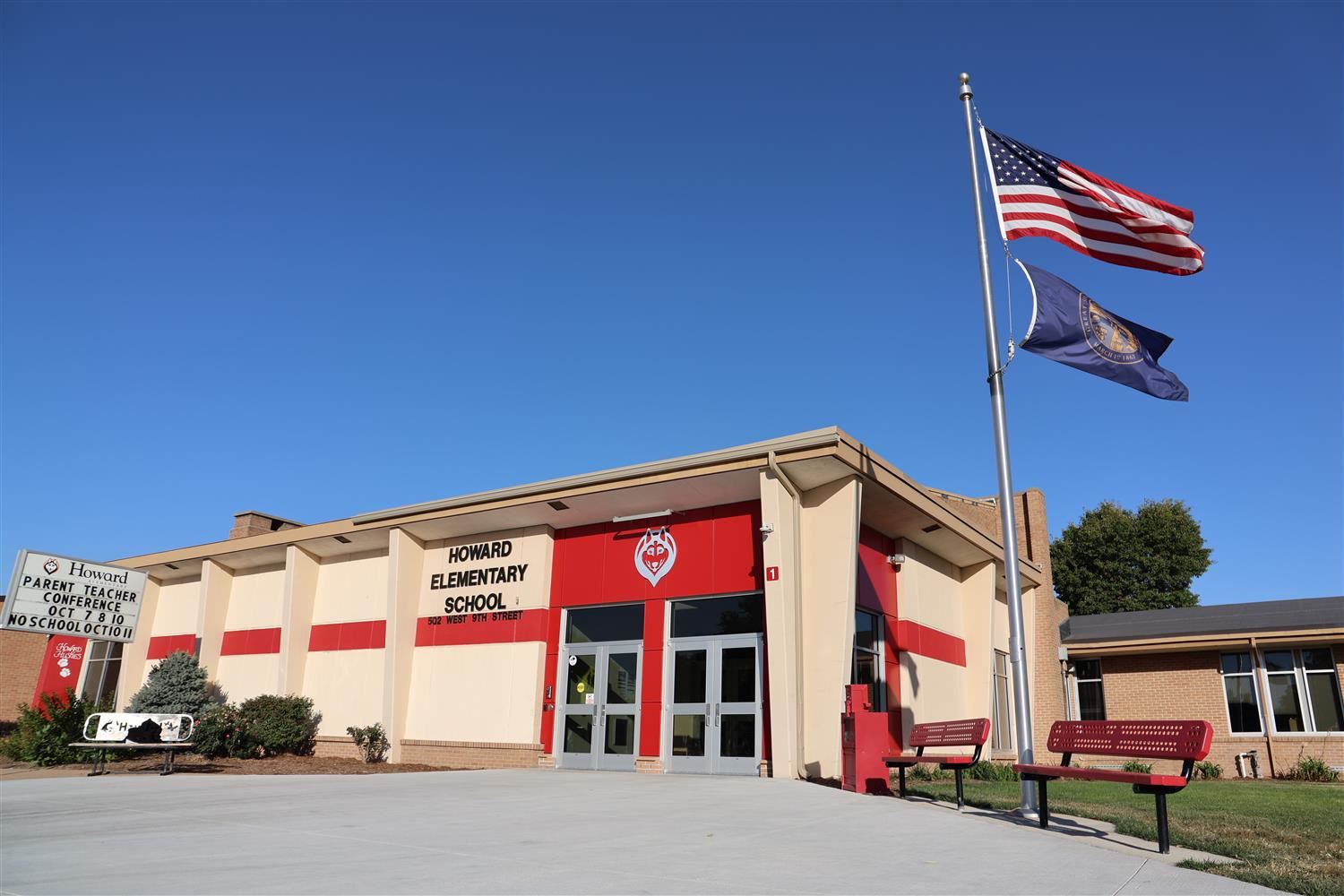Howard Elementary outdoor facade with American and Nebraska flags flying.